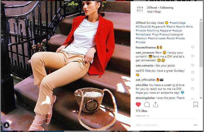 Woman sitting on steps wearing 209wst clothing