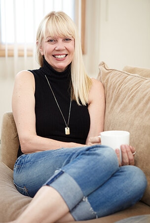 Woman sitting on a sofa with a coffee cup