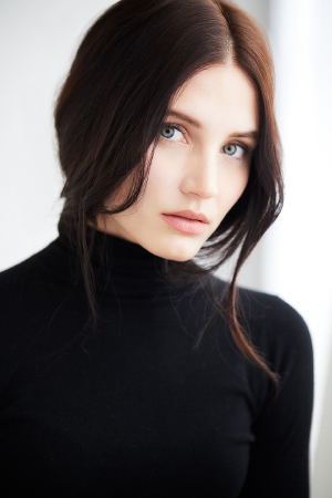 Beauty shot of young woman next to a large window