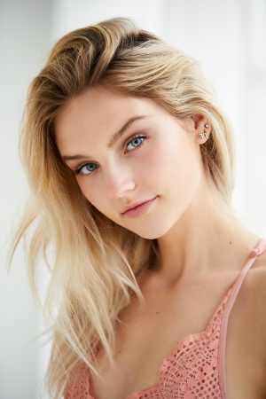 Beauty shot of young woman next to a large window